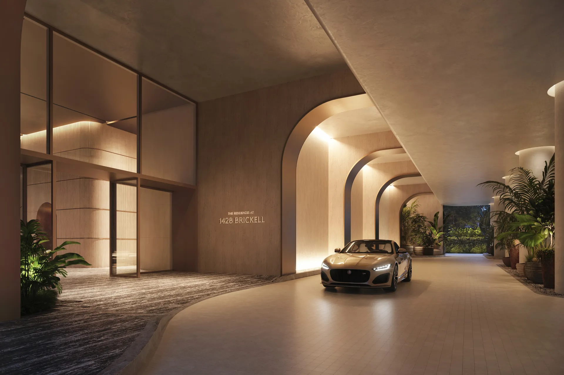 1428 Brickell — porte-cochère de acceso, con la placa The Residences at 1428 Brickell sobre el muro