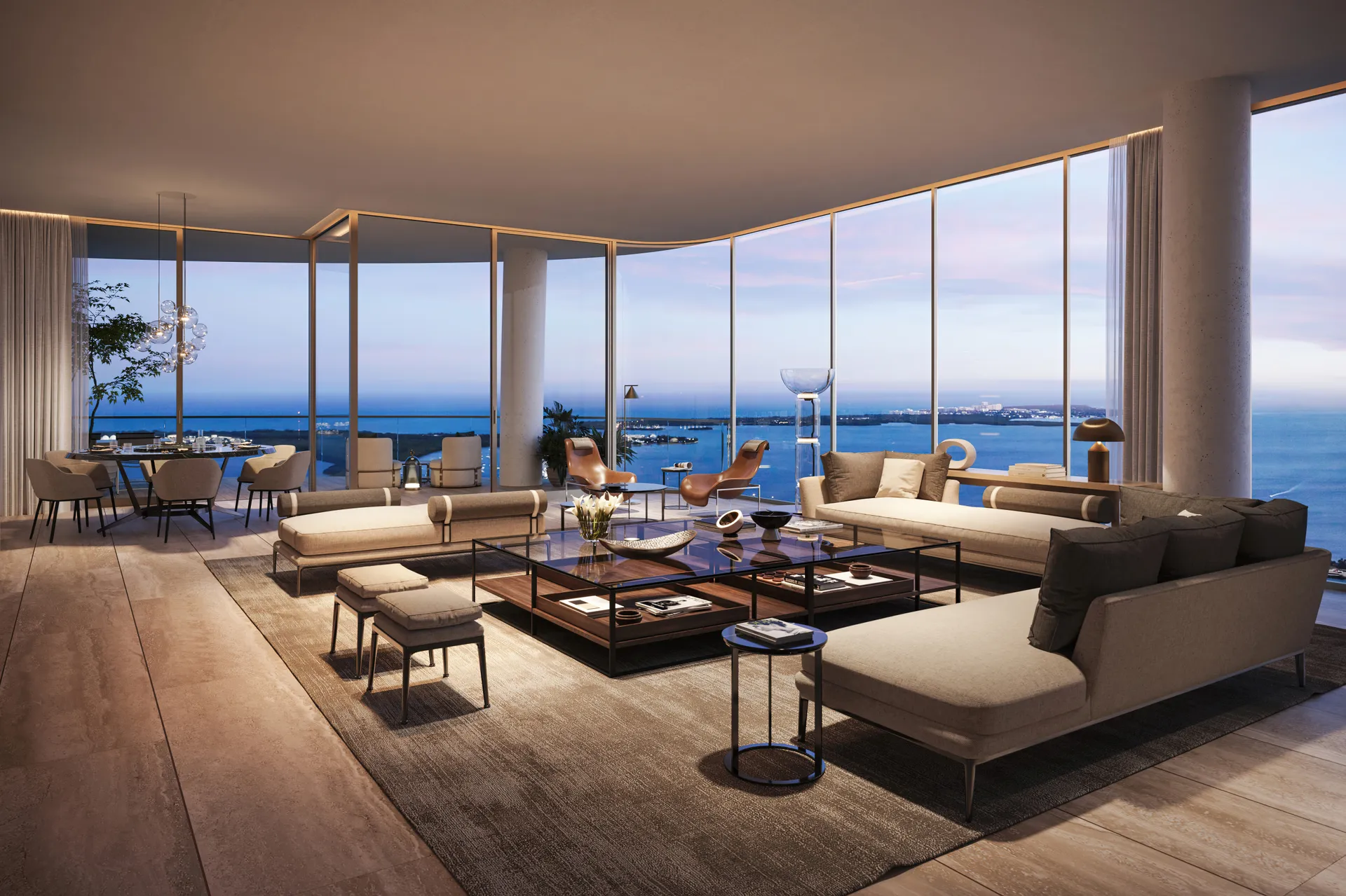 1428 Brickell — sala y comedor de una residencia modelo, con ventanales curvos de piso a techo hacia la bahía