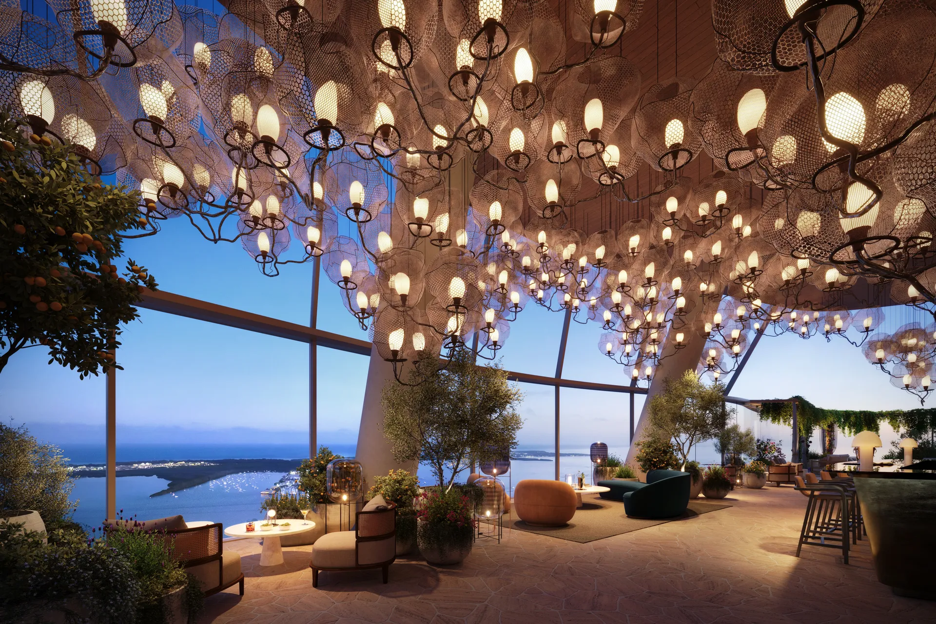 1428 Brickell — salón en la azotea con vista panorámica a la bahía al anochecer