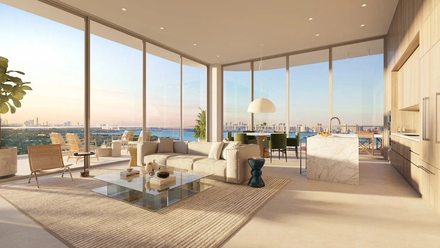 72 Carlyle Miami Beach Residences — sala con muro de vidrio curvo y vista panorámica al agua