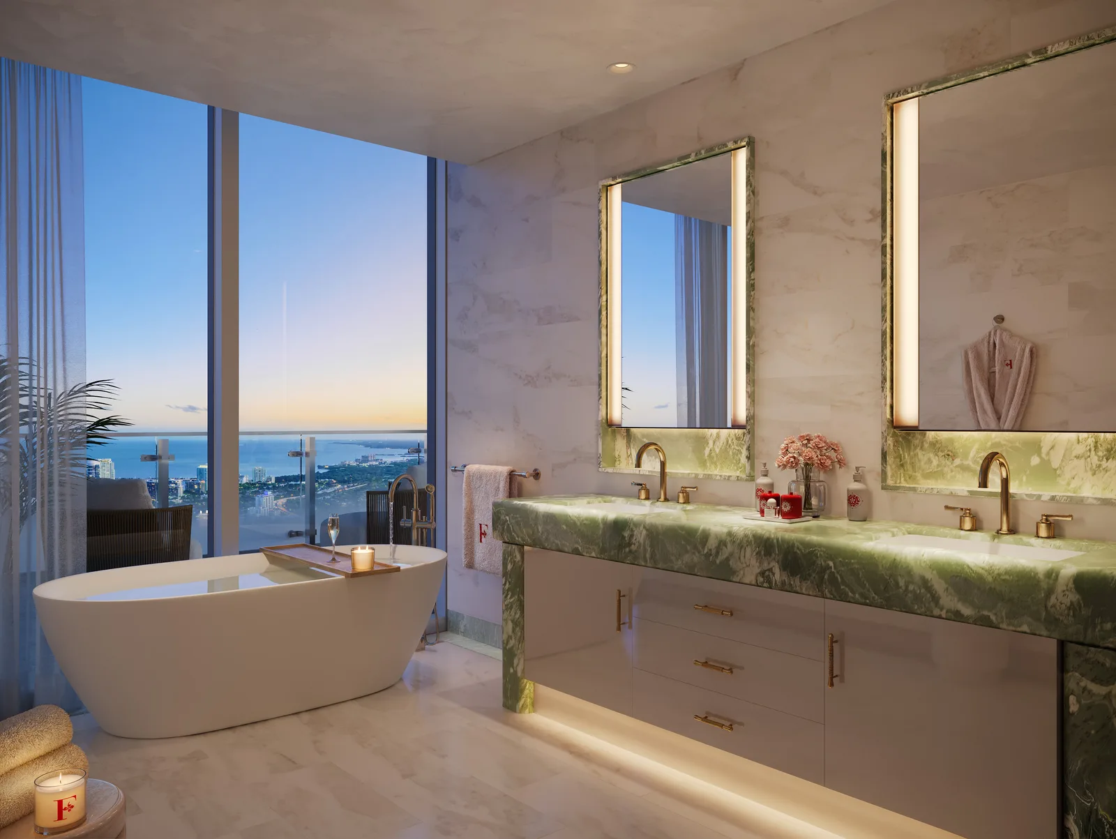 Baño principal de una residencia con mármol verde, tina independiente frente al ventanal y vista a la bahía