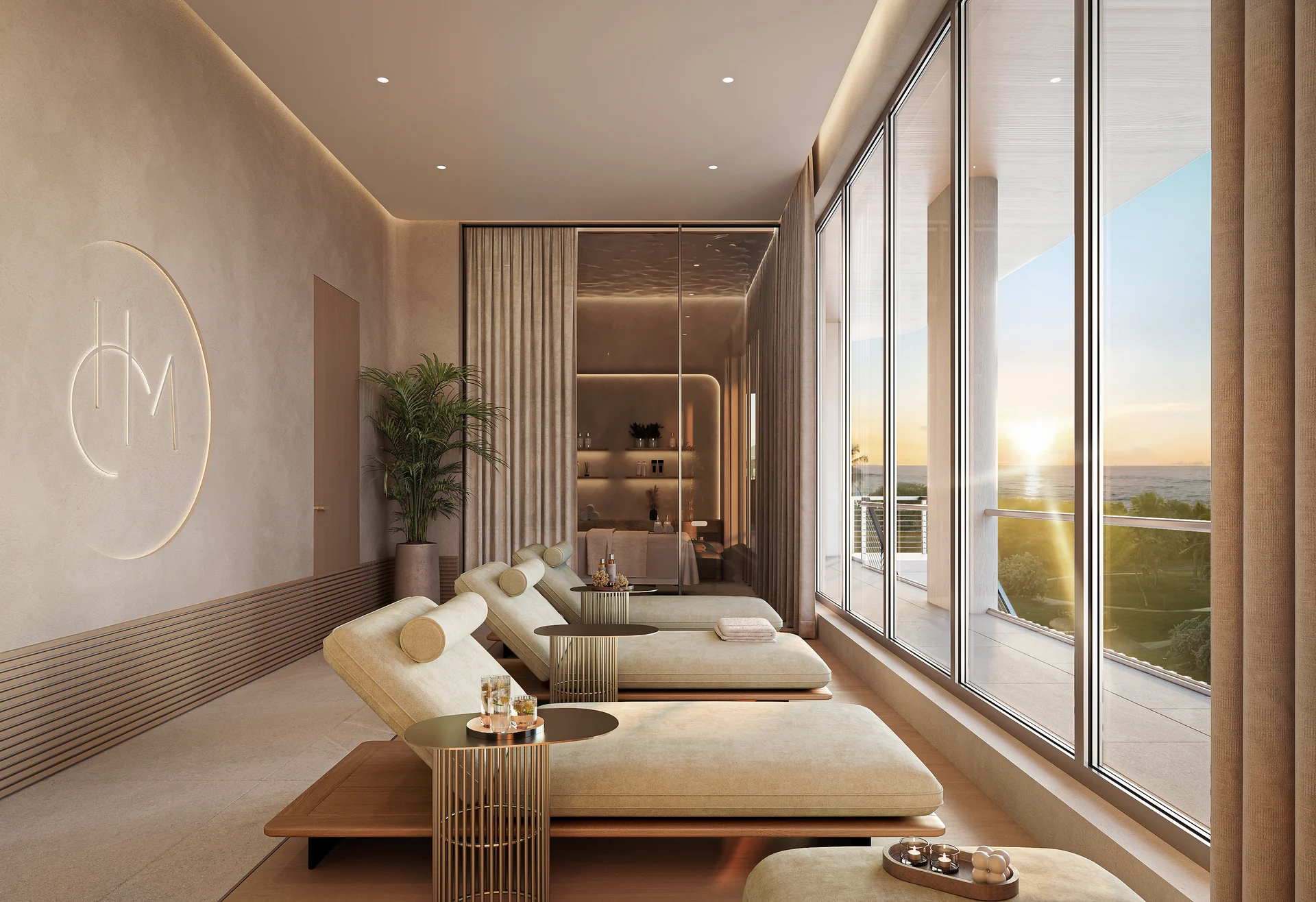 Hollywood Moon — sala de descanso del spa con camillas alineadas frente a los ventanales y el monograma del edificio grabado en la pared