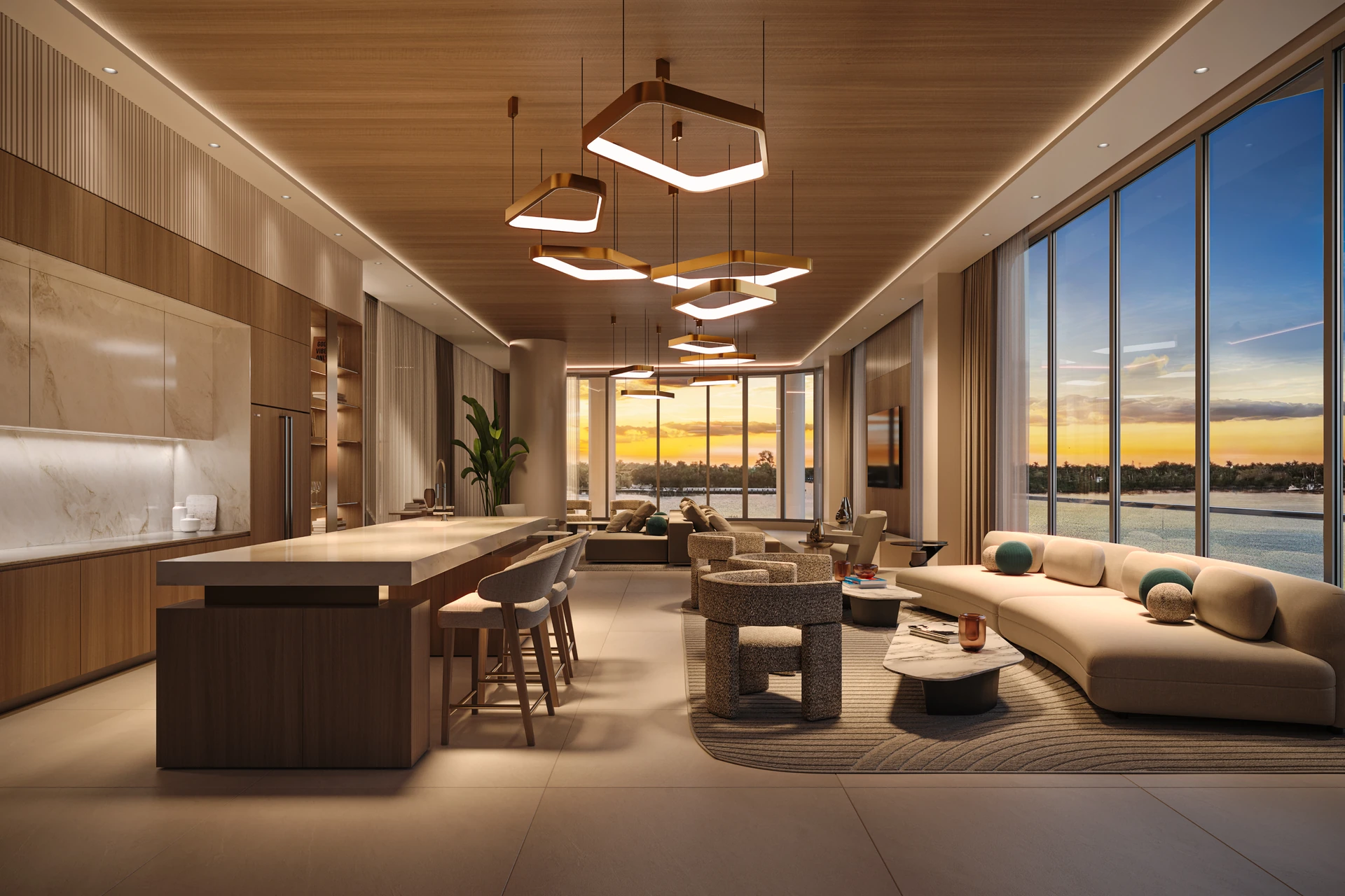 Hollywood Moon — planta abierta de una residencia grande: cocina con isla y desayunador, sala y comedor bajo un cielorraso de madera, con el atardecer sobre el agua al fondo