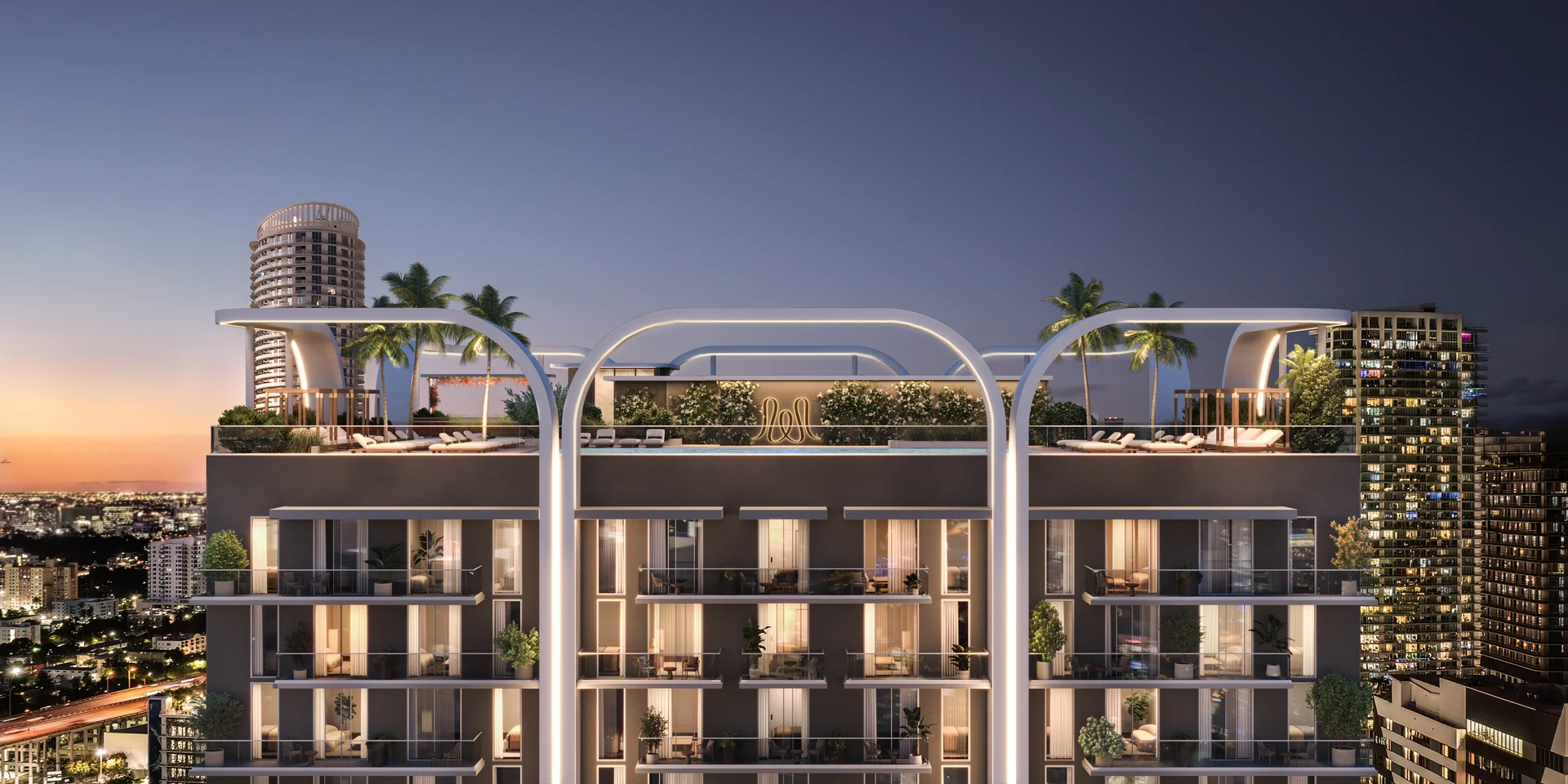 House of Wellness — fachada nocturna de la torre con balcones iluminados sobre el skyline de Brickell