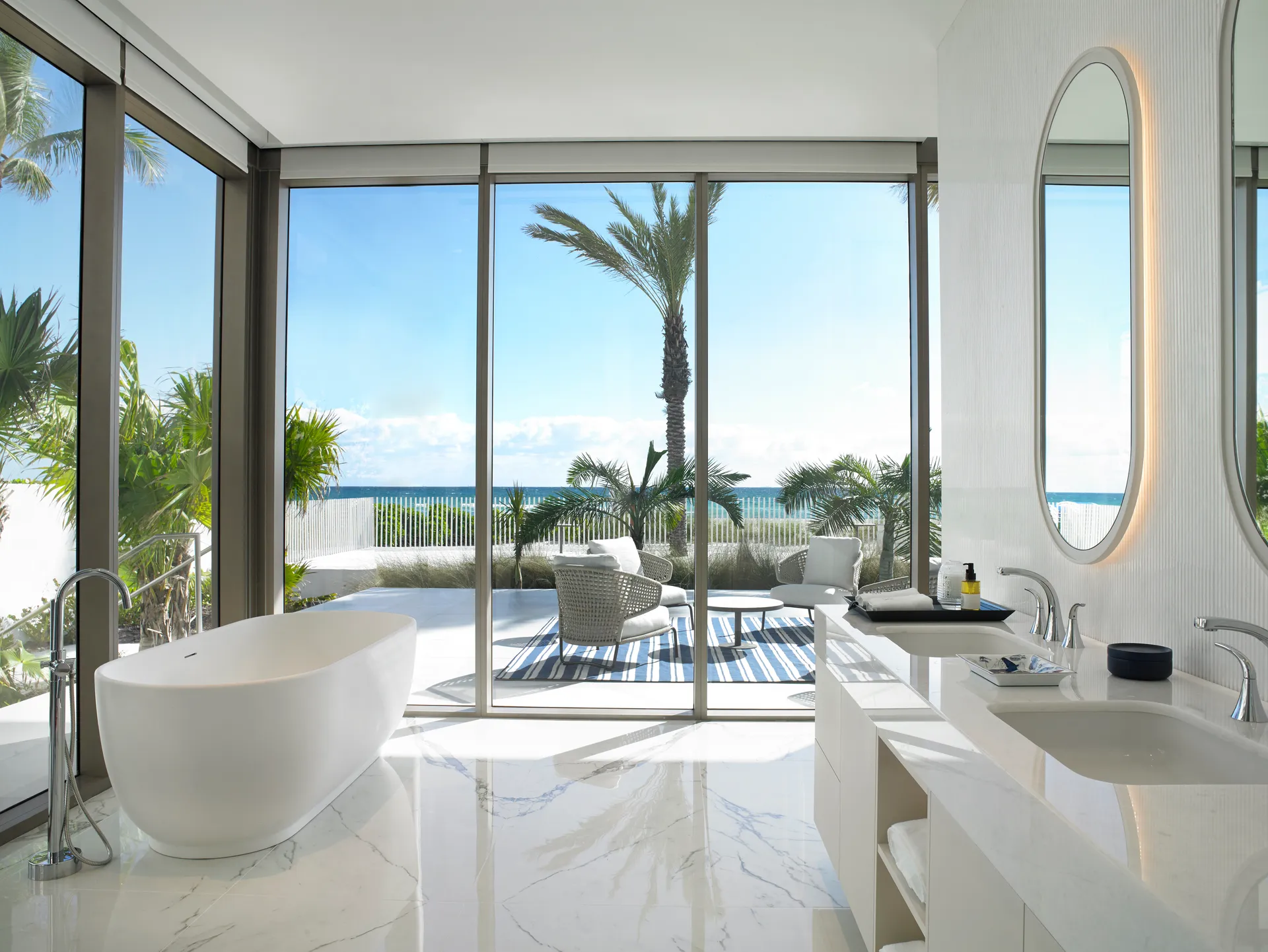 The St. Regis Residences, Sunny Isles Beach, Miami — baño principal con tina exenta y terraza privada frente al mar