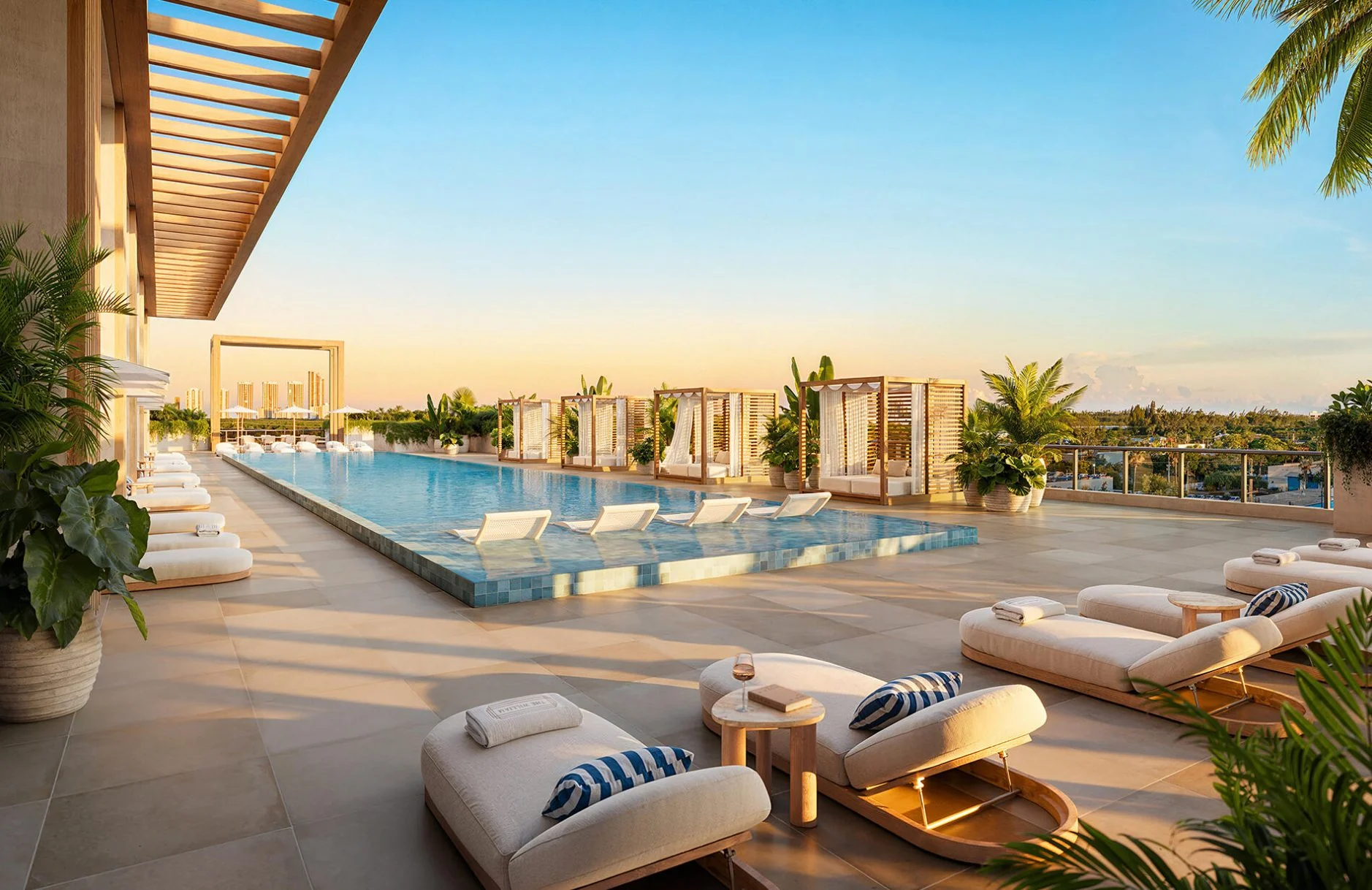 The William — piscina estilo resort y solárium con camastros y pérgolas al atardecer