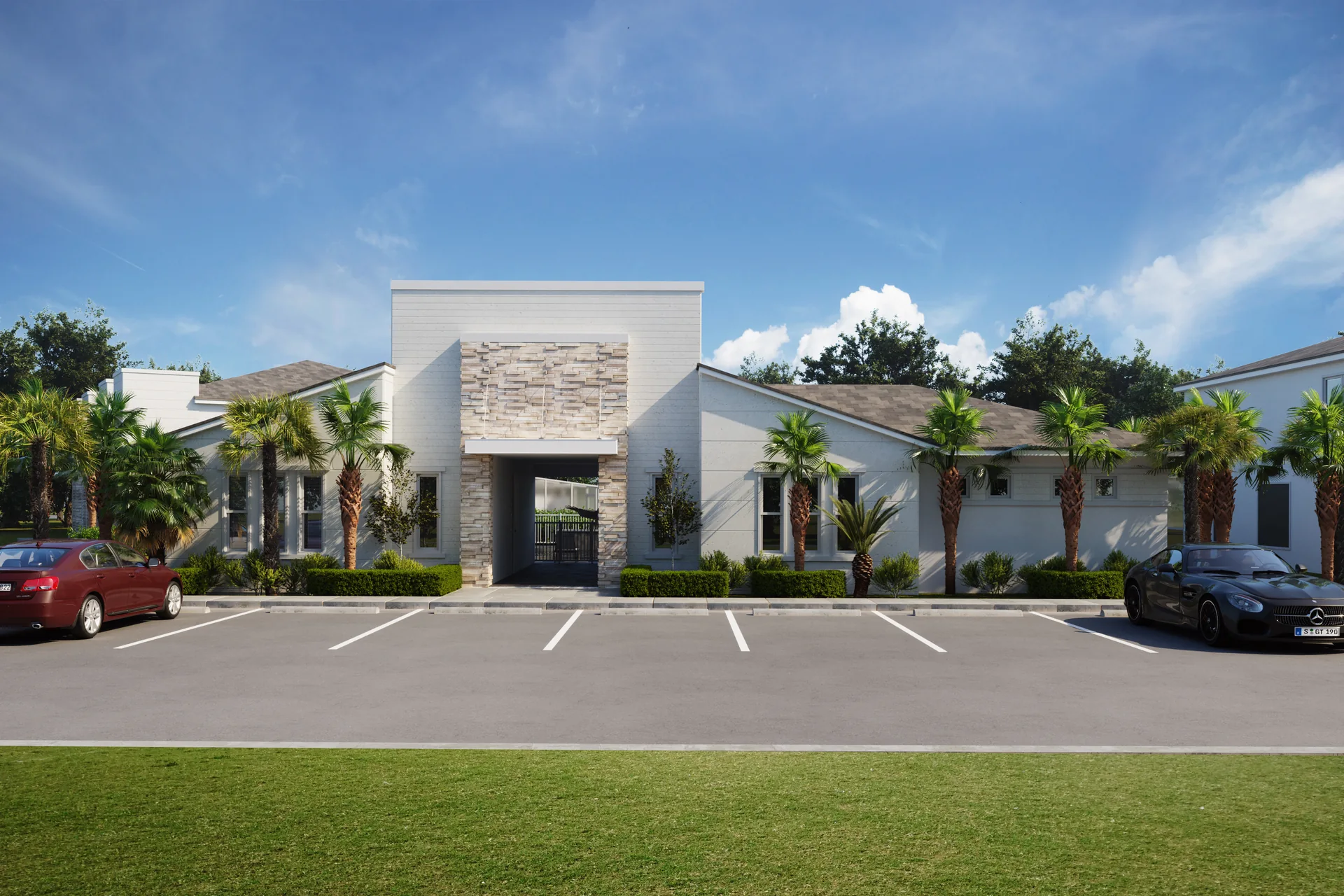 Tranquility Townhomes — entrada de la comunidad con fachada de stucco blanco y acento de piedra